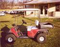 Seen is a roofed cart with a square, 8-inch-high cargo storage box that extends out beyond the back of the cart.