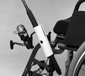 The holder (with rod and reel inserted) shown attached to the chairâ€™s left-front frame.